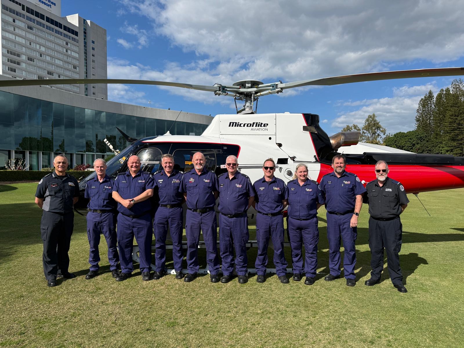 Conference attendees in front of one of the helicopters on display