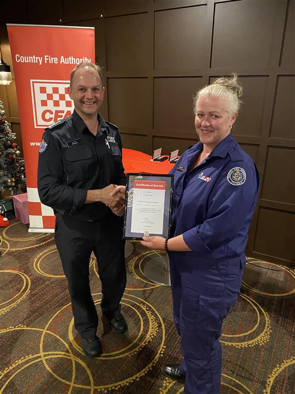ACFO Chris Eagle presents 5 year certificate of service to Maria Price