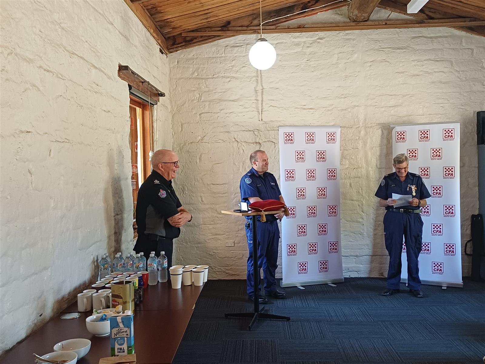 MC Commander David Ferguson (D05) and SWR DCO Adrian Gutsche watching on as Chris gives thanks and talks about his time in CFA after receiving CFA Life Membership Award