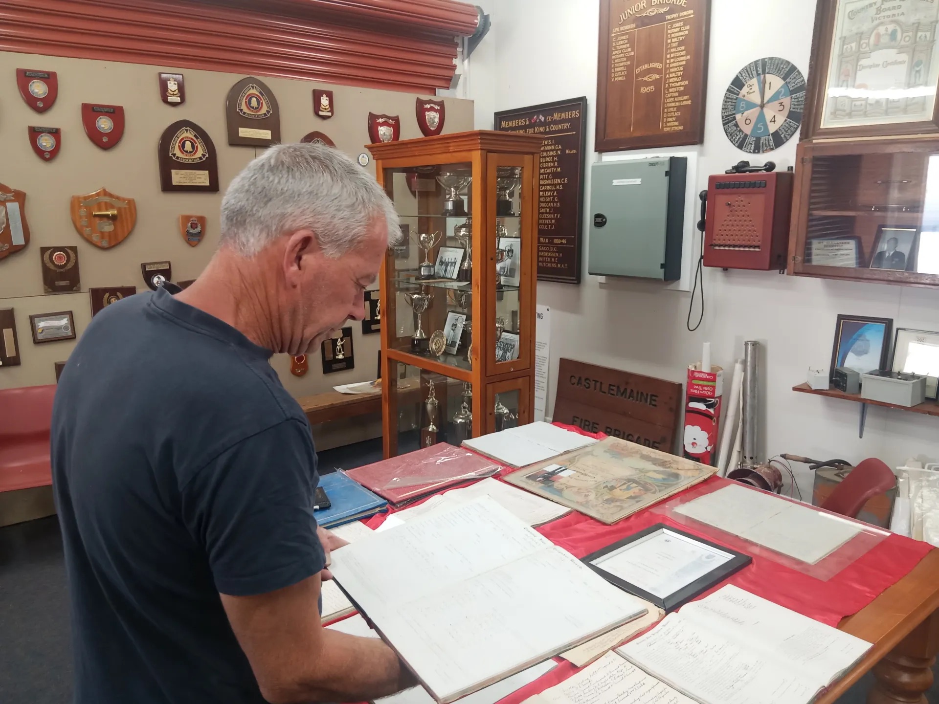 Terry Franklin (Castlemaine Fire Brigade Captain 2013-2025) shows one of the many Fire Books in the museum. Picture: Supplied