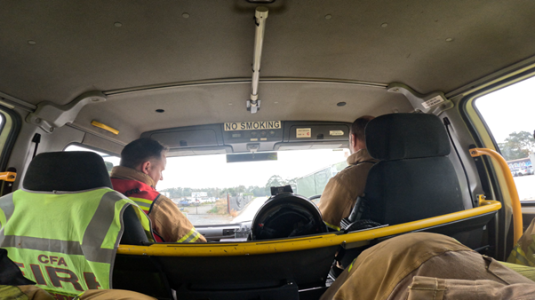Chest camera shows crew in back of truck receiving a briefing on the way to the incident