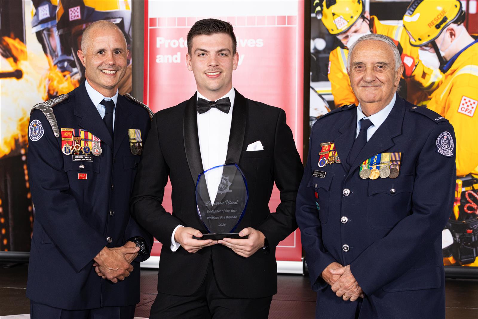 Firefighter Cameron Ward is presented with his Firefighter of the Year award by Captain Michael Wells & Ex Captain Darryl Wells AFSM OAM JP