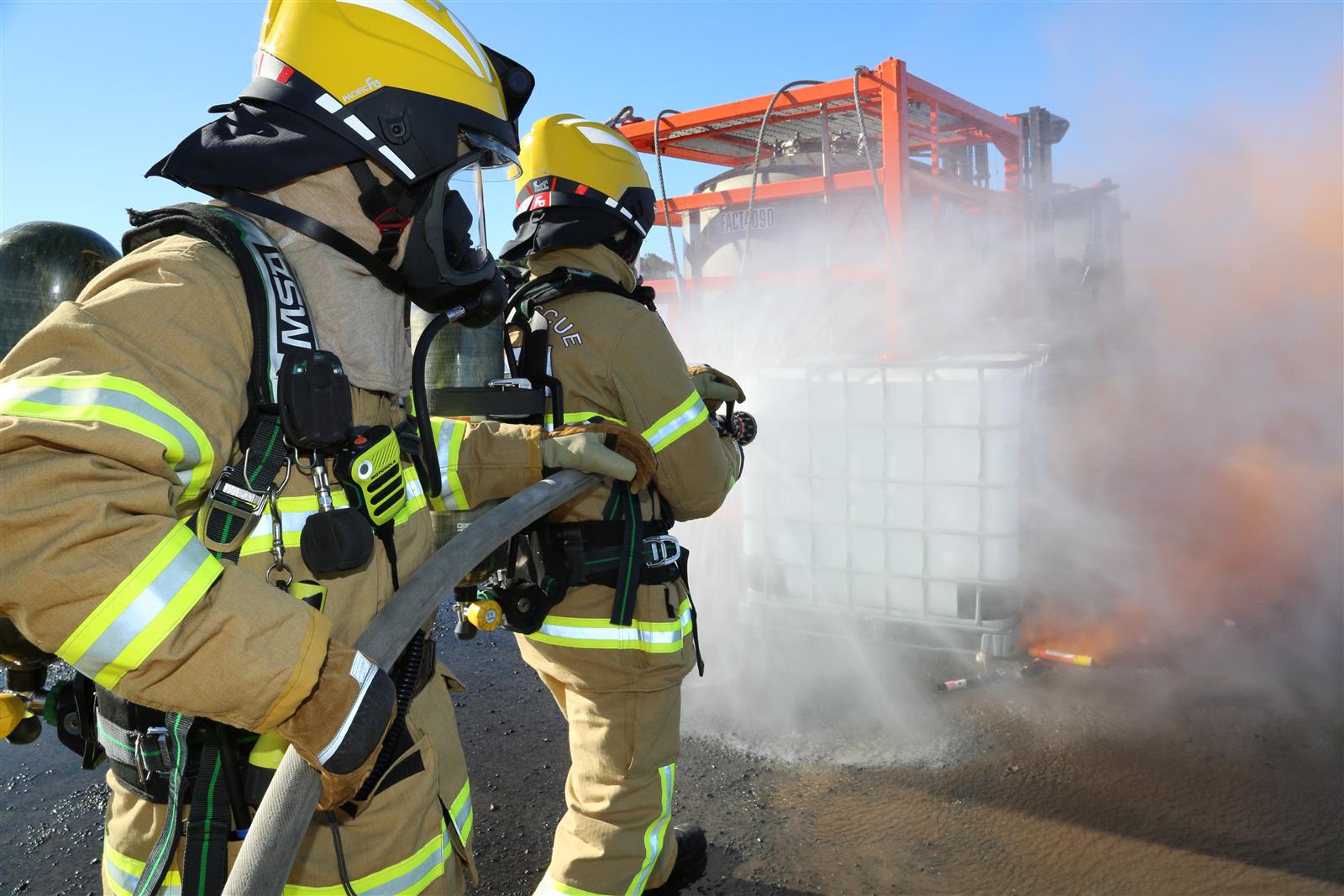 Toora members use a fine-spray to control the HAZMAT chemical spill simulation