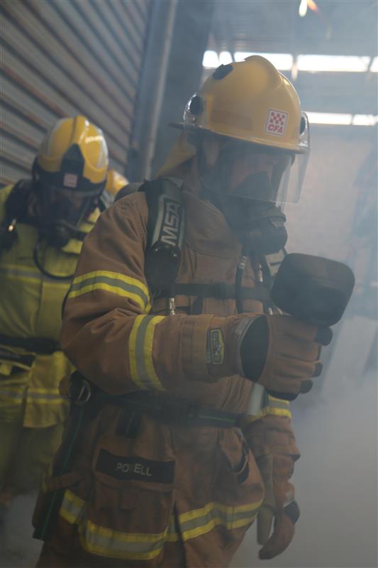 Foster member Robert Powell uses a Thermal Imaging Camera to navigate through the smoke.