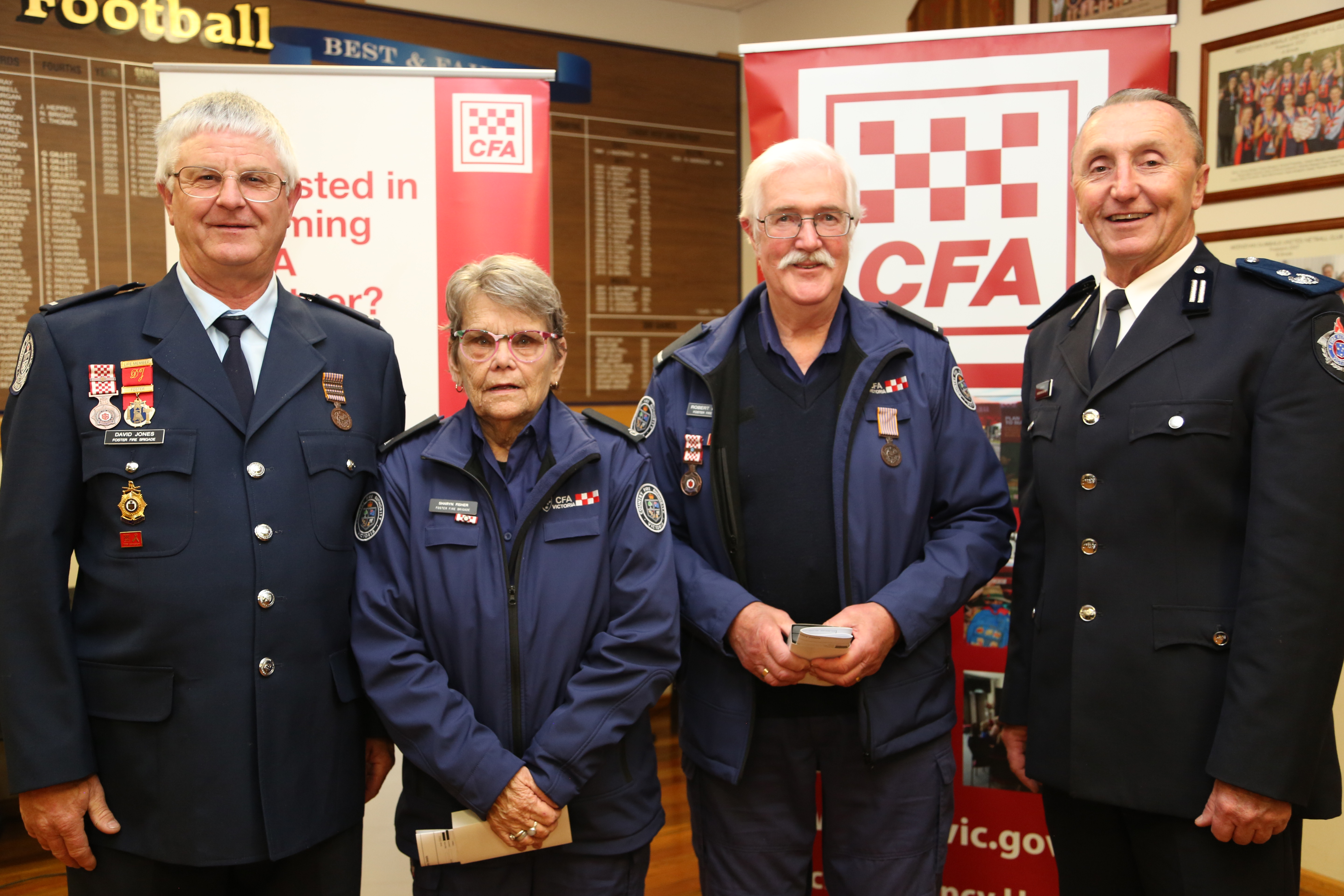 Foster Captain David Jones, left, with service medal recipients Sharyn Fisher and Rob Powell and Commander Andrew McCartney.